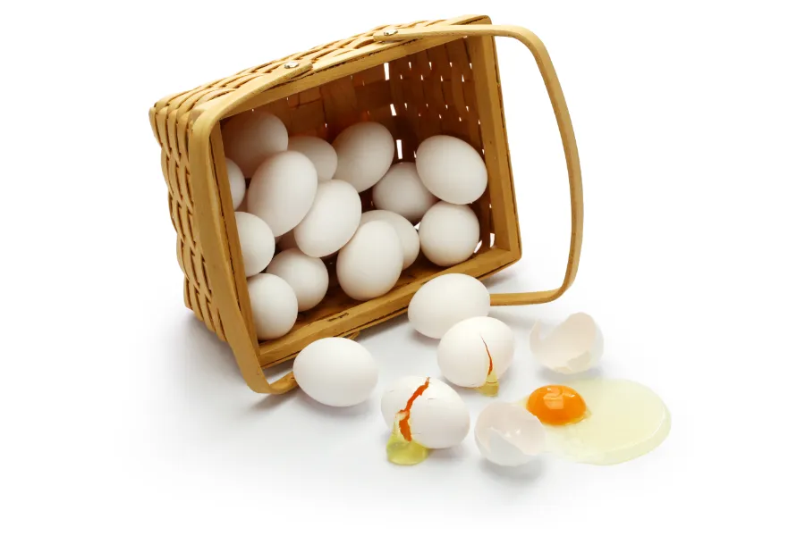 cracked eggs spilling out of basket