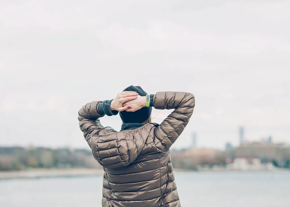 man with hands on head looking into distance