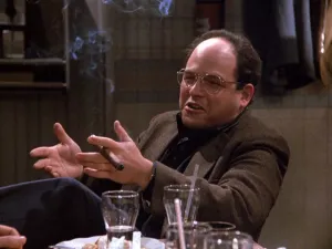 george sitting at table with cigar