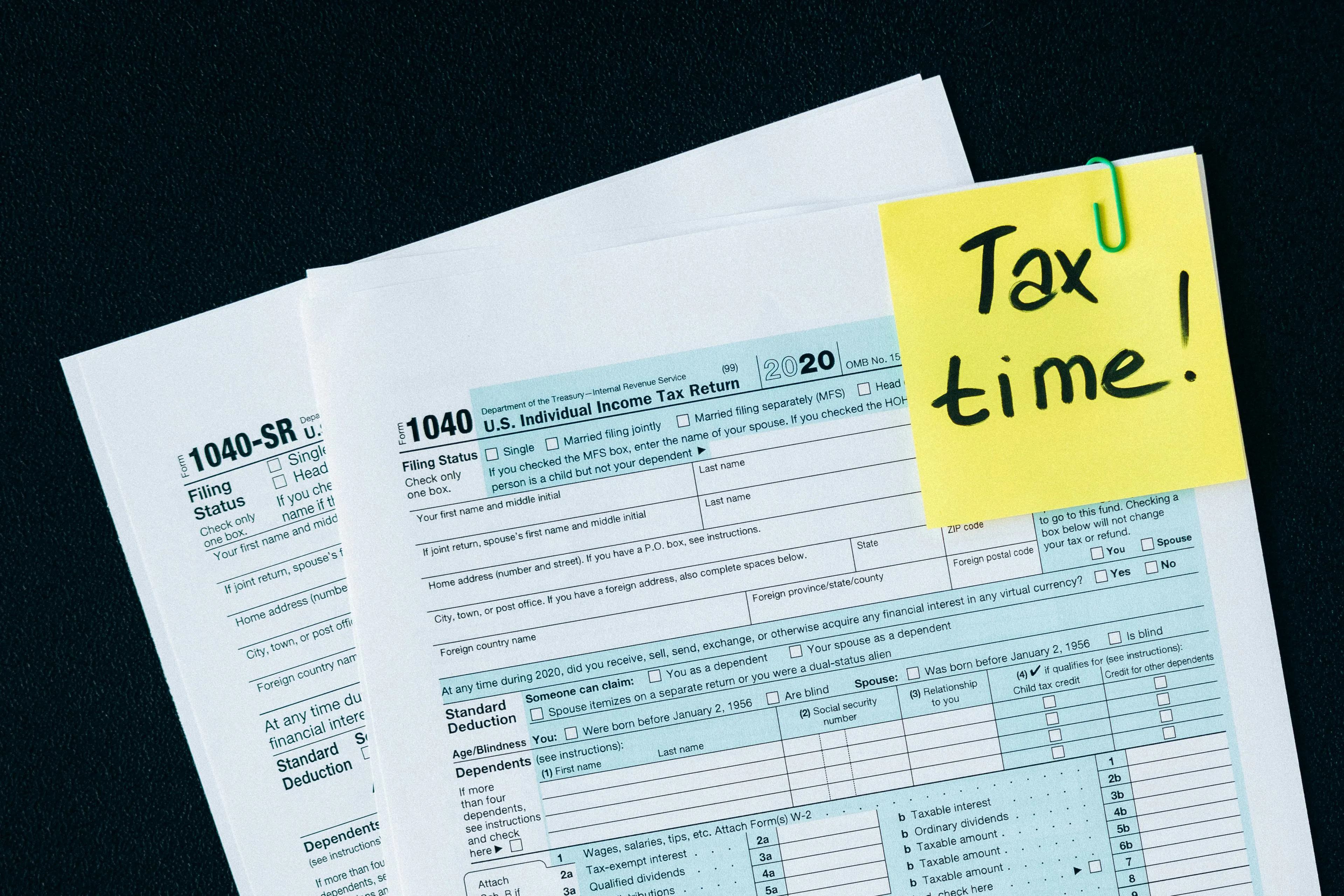 1040 tax forms with tax time sticky note