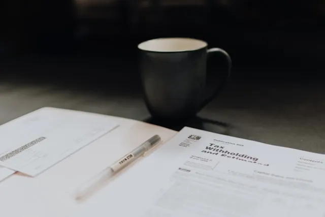 Tax Forms with pen and coffee mug
