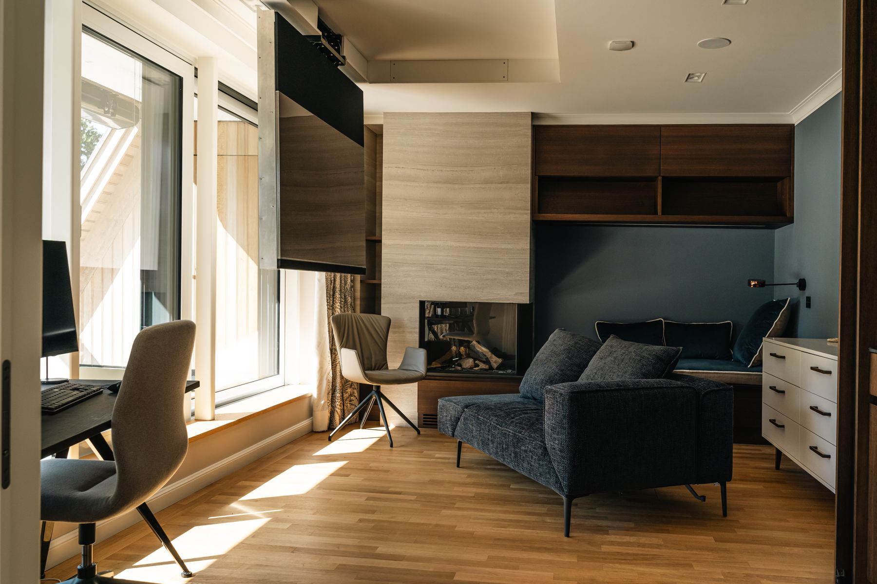 Arbeitszimmer mit Kamin, motorisch schwenkbarem Fernseher und Leseecke