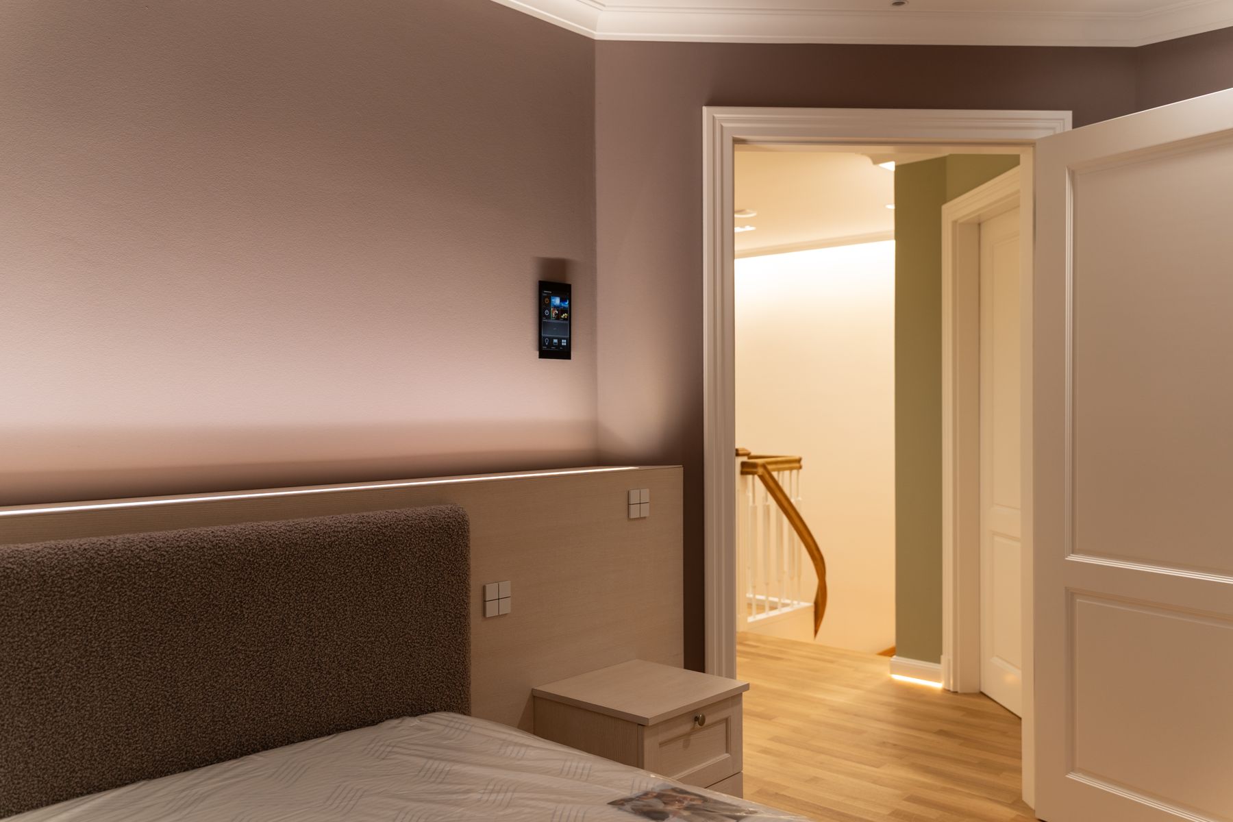 Schlafzimmer am Abend mit indirekter Beleuchtung, Touchpanel und Tastsensoren am Bett