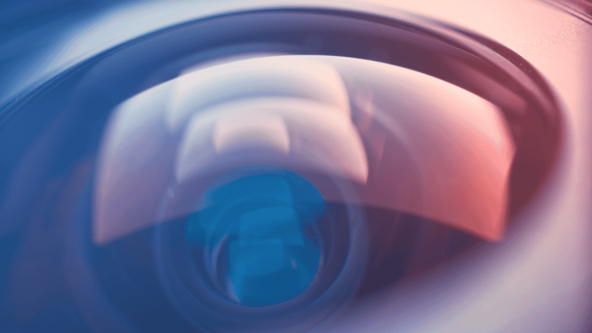 Closeup of a camera lens, with red and blue lighting