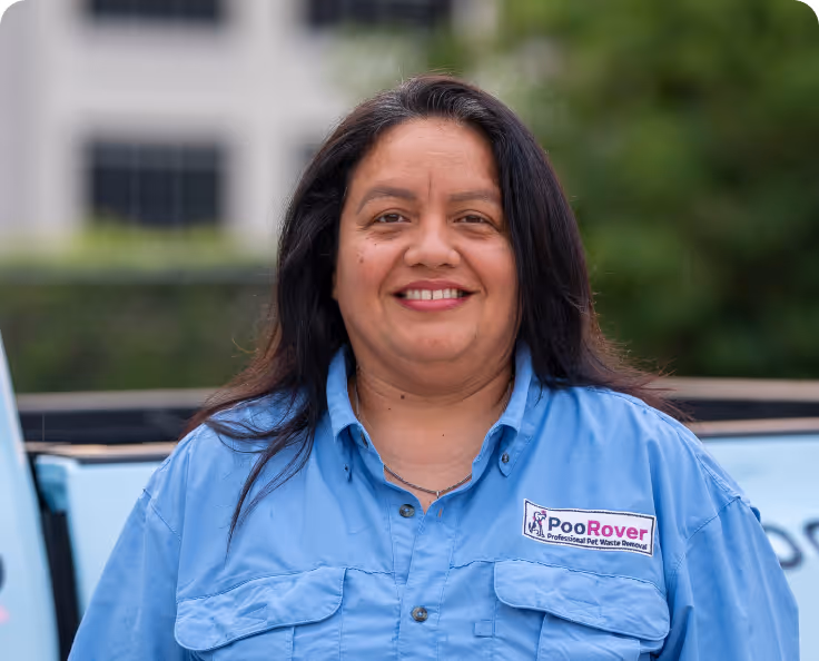 Smiling woman with dark hair wearing a blue shirt with a PooRover logo for professional pet waste removal.