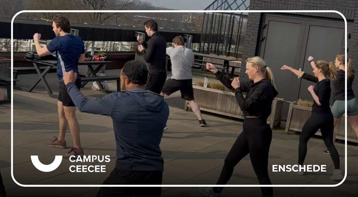 Groep mensen volgt een bokstraining op het dakterras van Campus CeeCee in Enschede