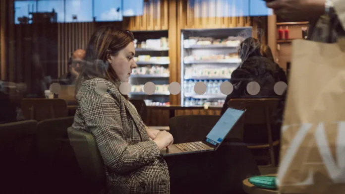Professional woman working remotely from a cafe in Moncton, NB