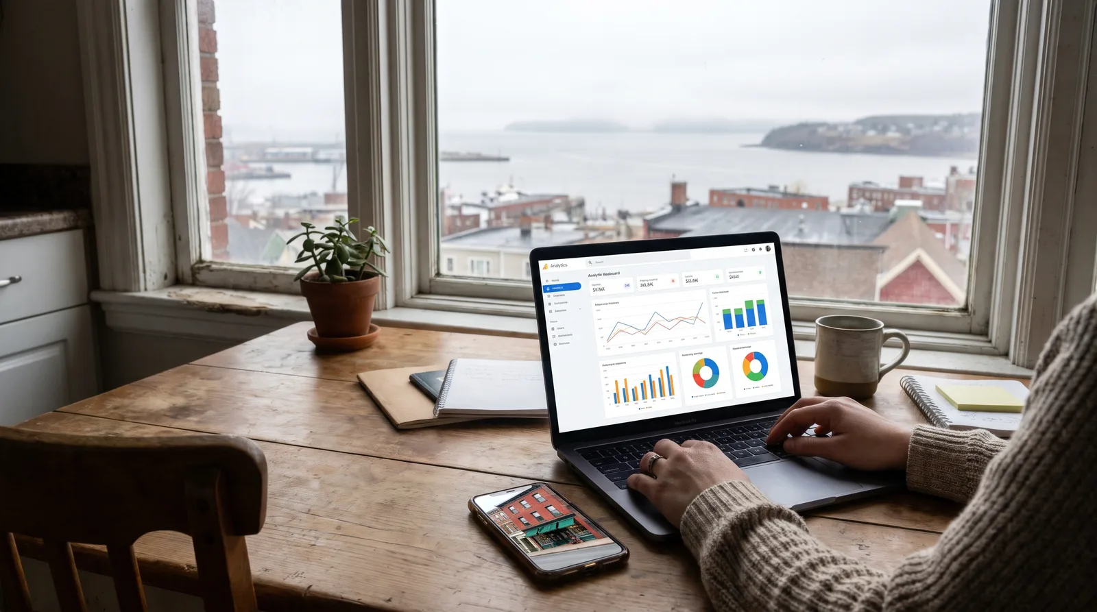 Laptop showing an analytics dashboard on a kitchen table, used to track Google Business Profile performance