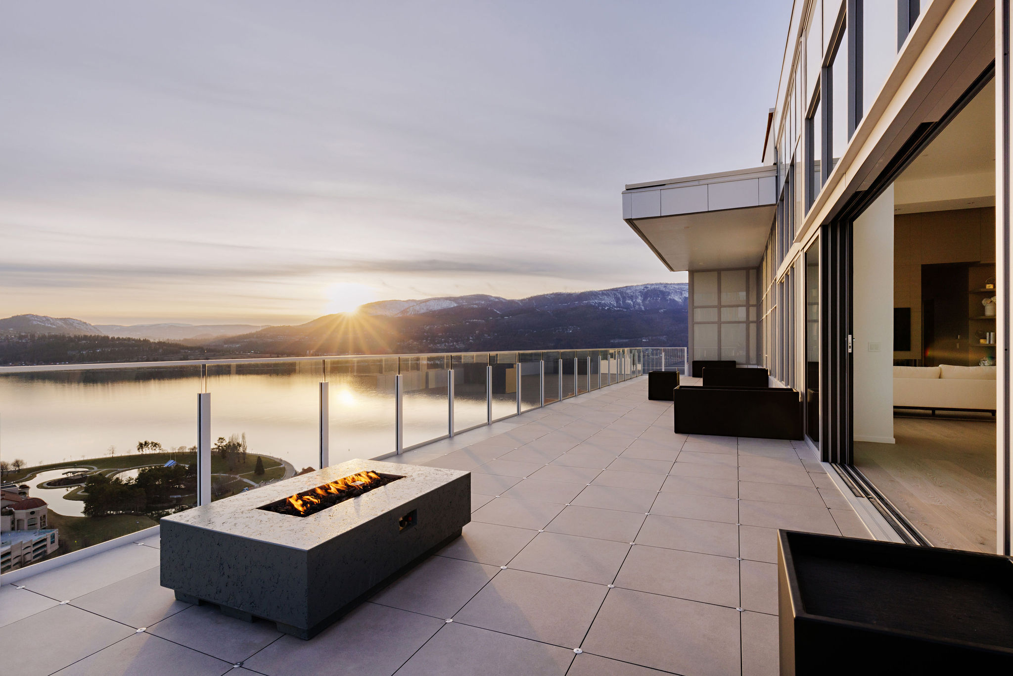 Balcony with fireplace during sunset at Okanagan Lake