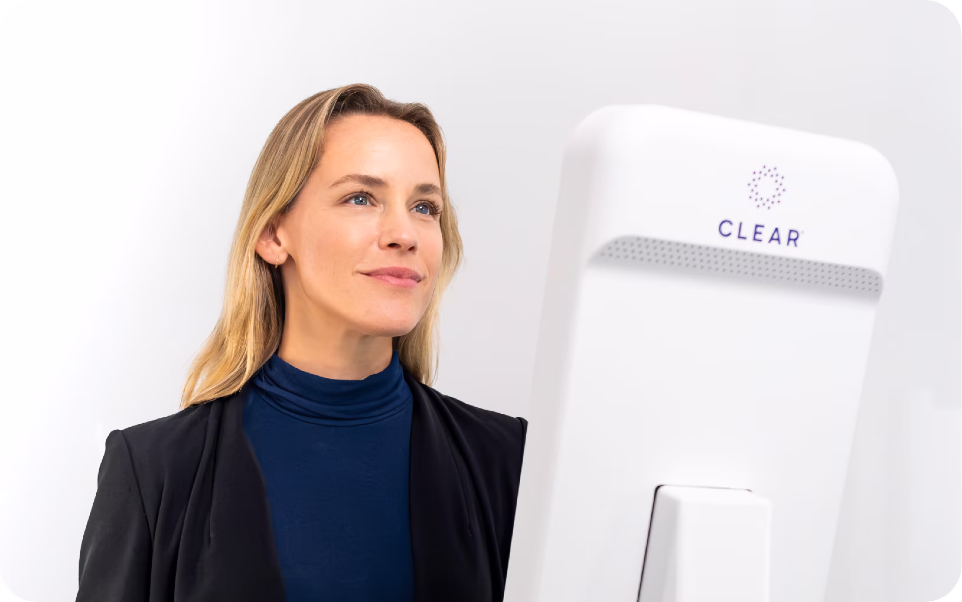 Woman verifying identity using new CLEAR pod
