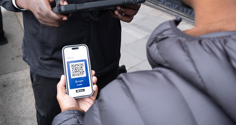 Person scanning CLEAR QR code at sports stadium