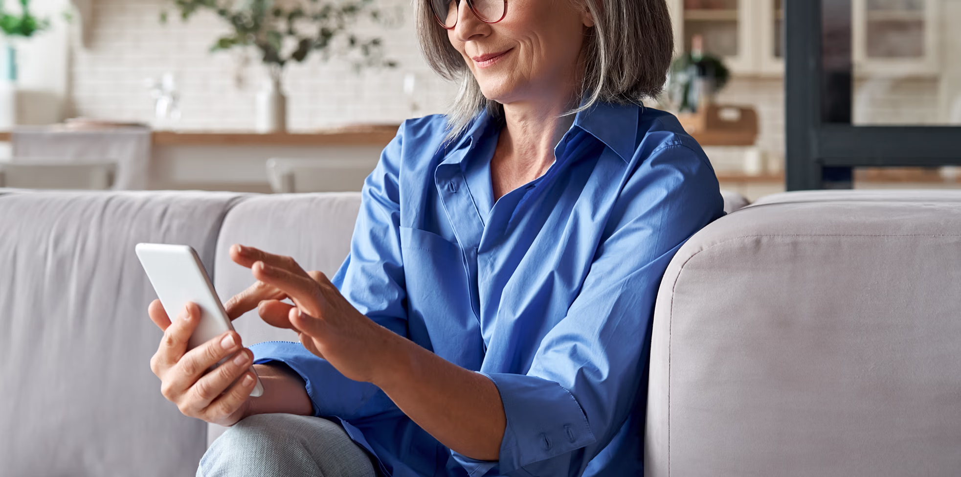 Elderly woman looking at phone