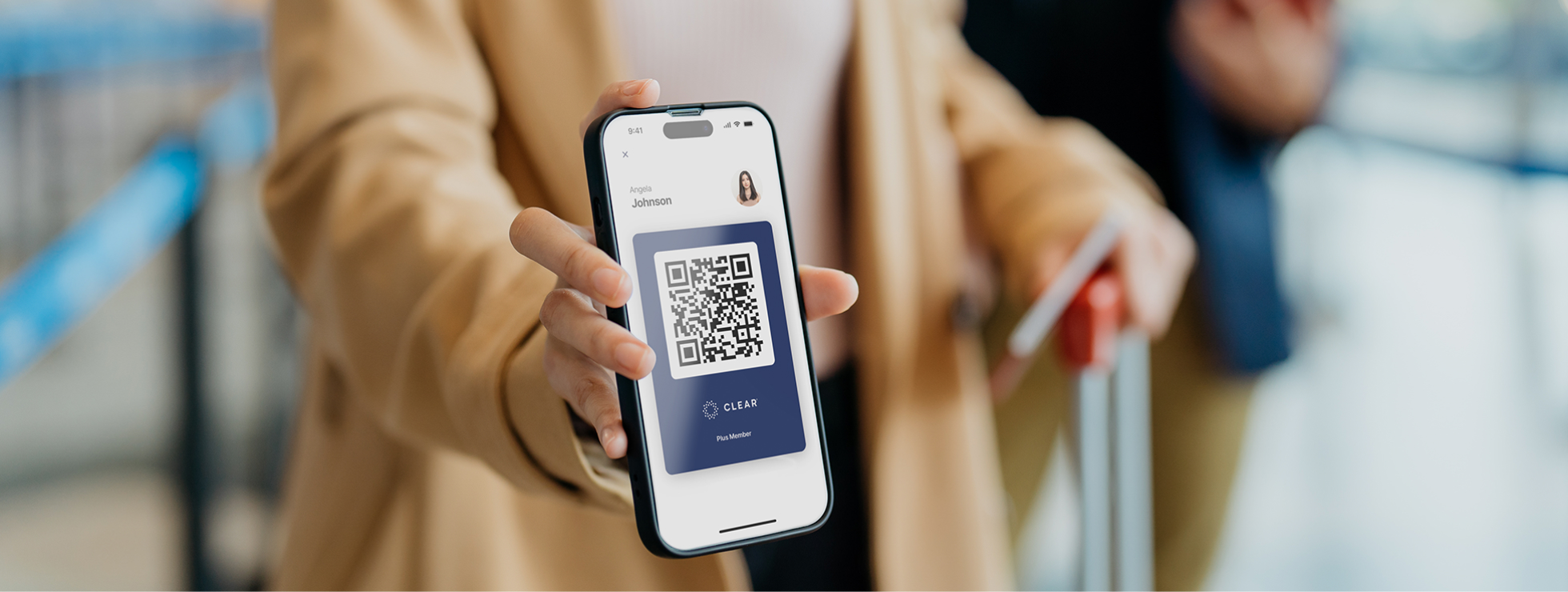Woman showing CLEAR Mobile QR code to security at SDF