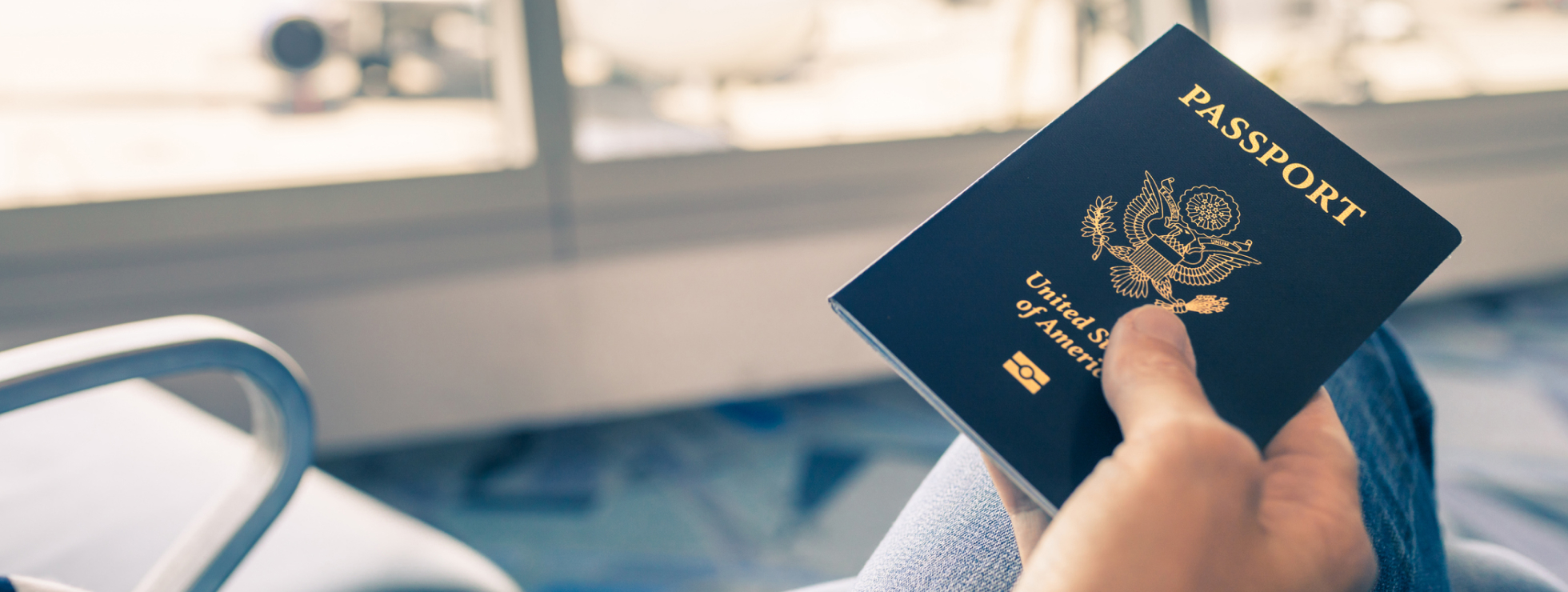 Man at the airport holding passport in his hand