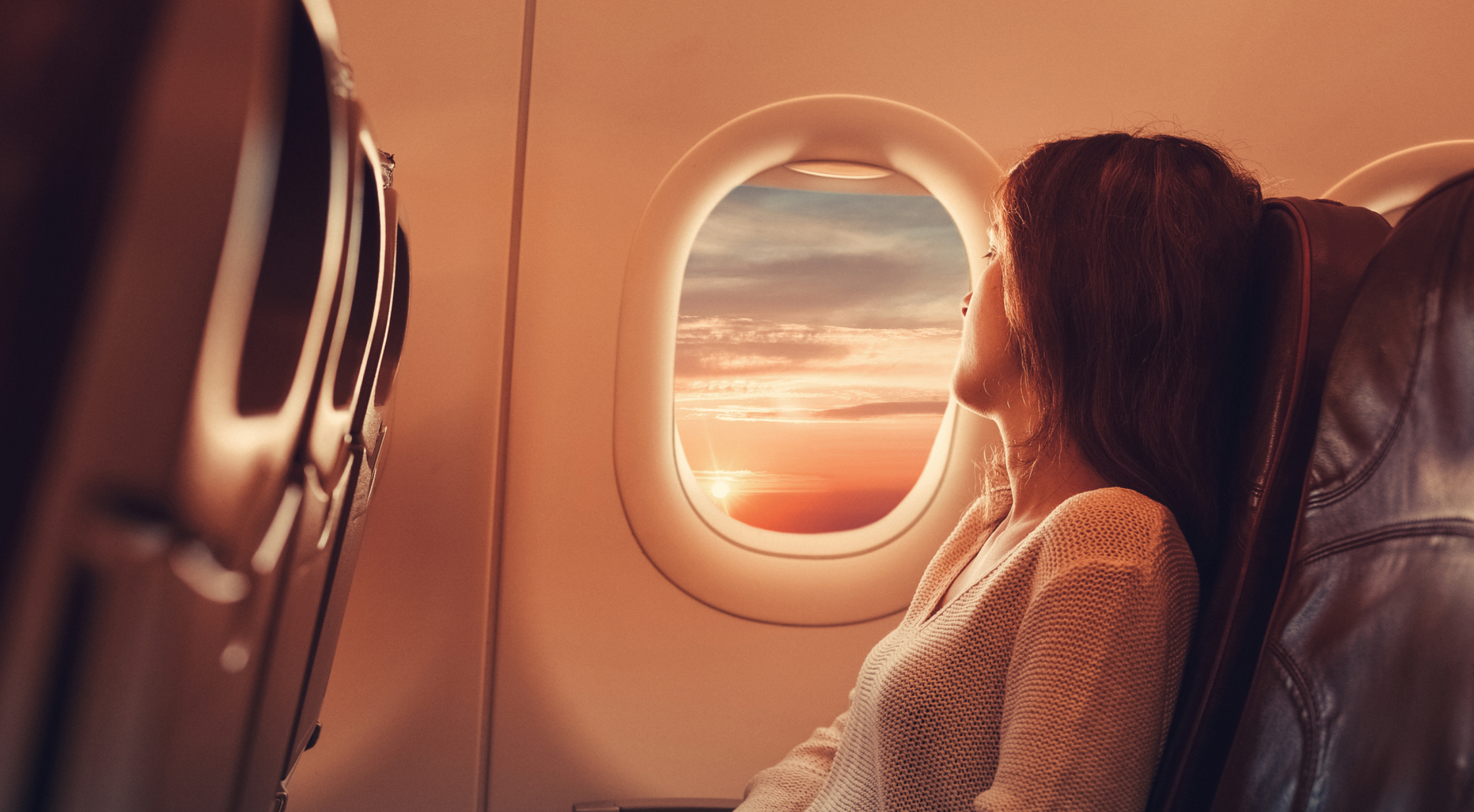 Image of Traveler looking outside of Plane WIndow