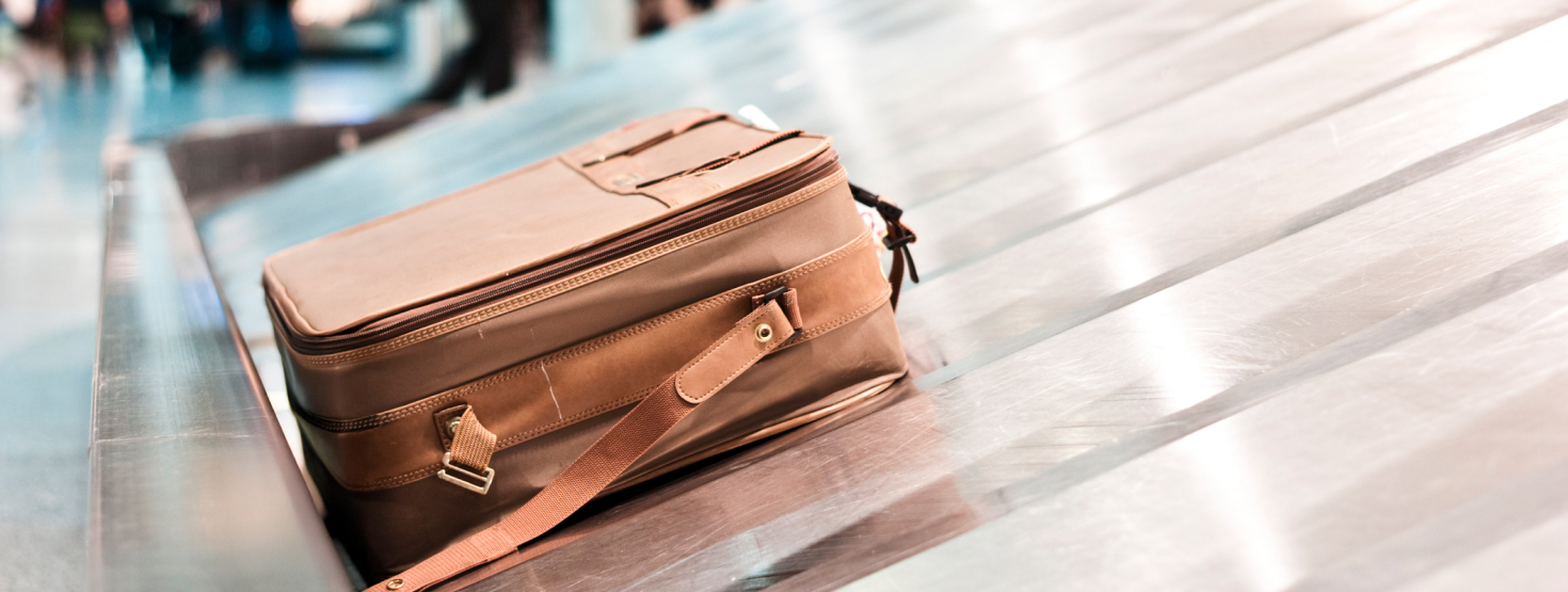 Brown luggage on a luggage carousel in the airport