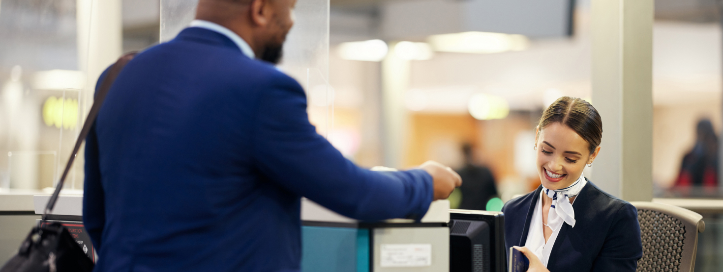 Person speaking to airline agent in airport