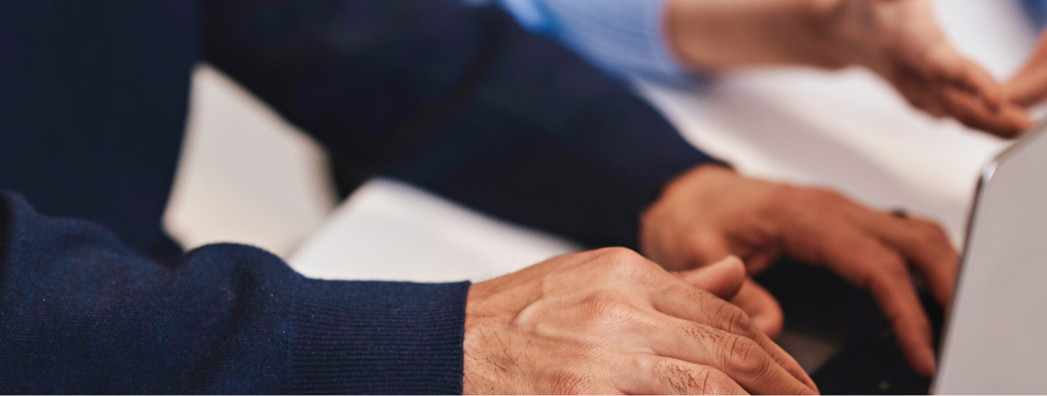 Couple sitting at computer and booking trip on Travel Tuesday