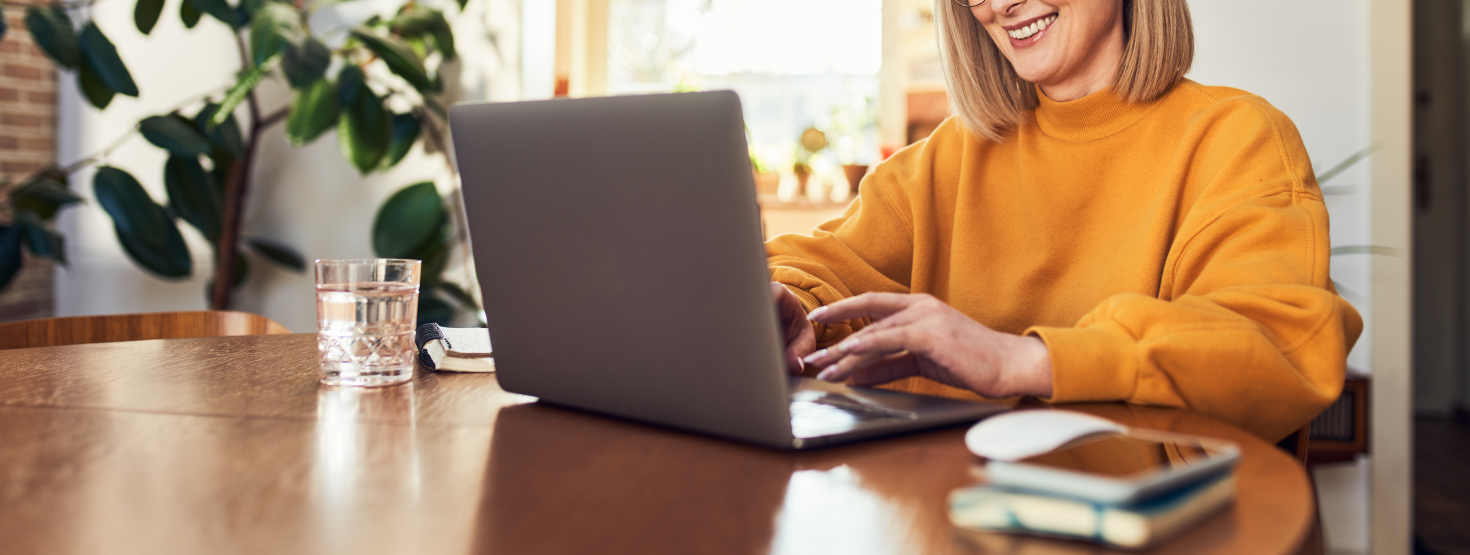 Woman smiling and typing on her computer