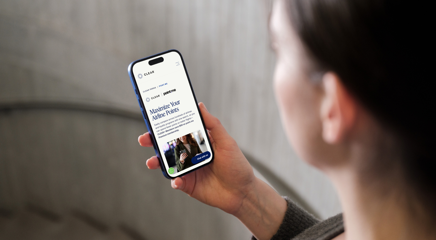 Woman looking at CLEAR and point.me partnership page on her phone
