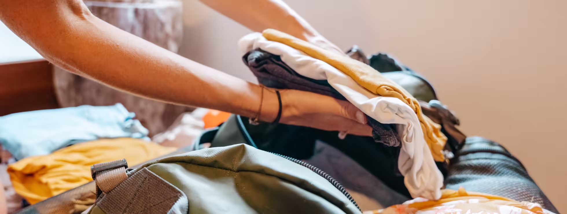 Image of person packing their luggage