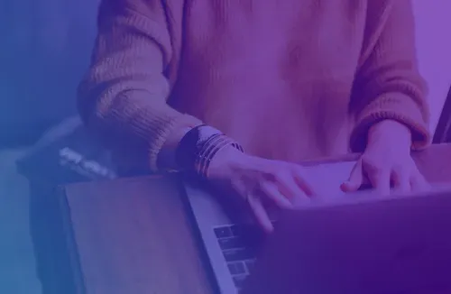 Someone writing social media posts on a laptop