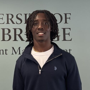 A man standing in front of a machine.
