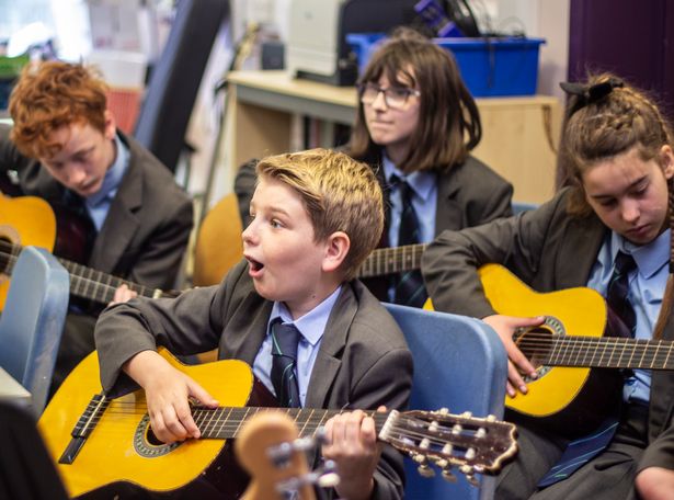 Students playing guitars