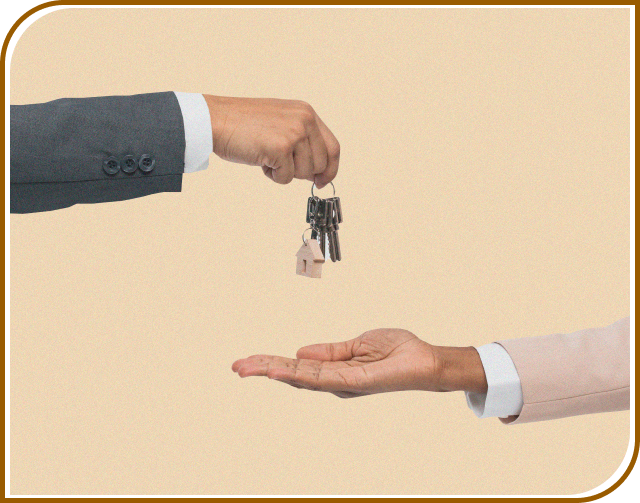 man gives key to another man to signify buying an selling of  houses

