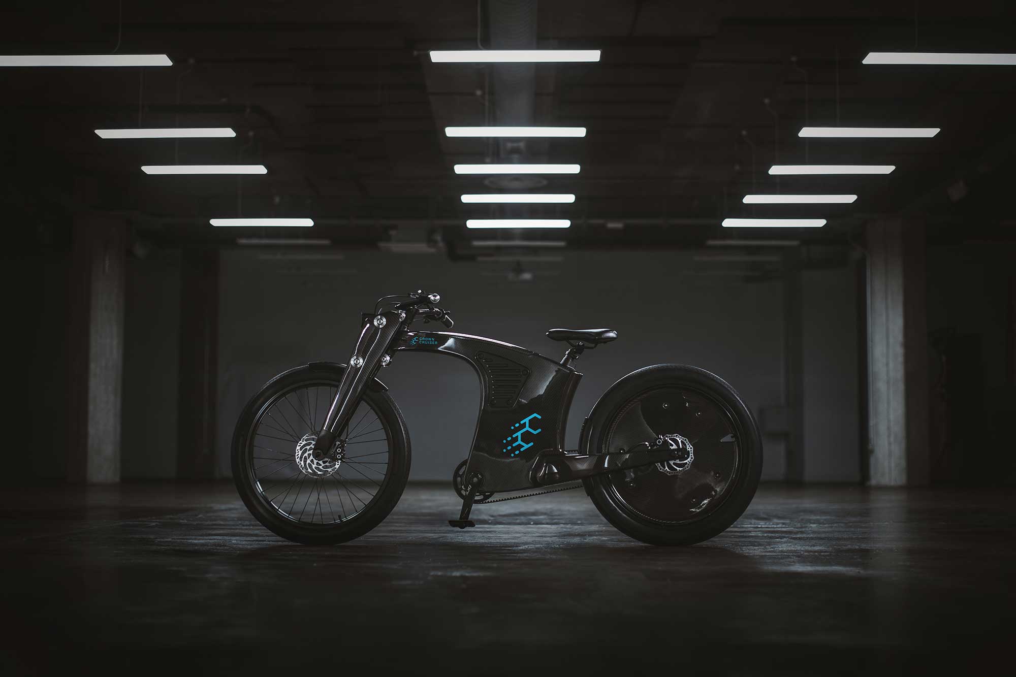 Side view hero shot of the crown cruiser electric bike in a well lit stylish warehouse