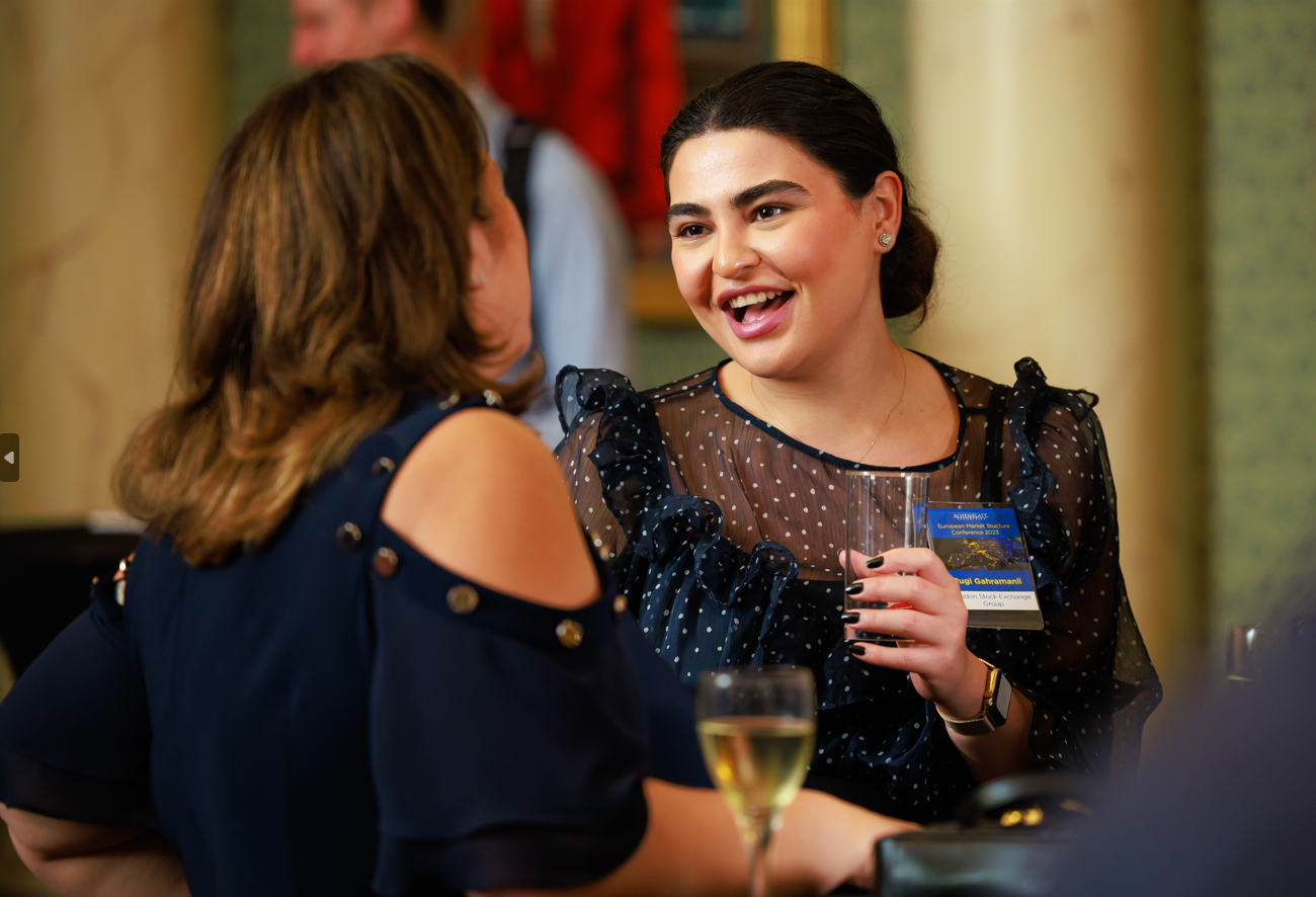 Rugi Gahramanli of London Stock Exchange Group networking at the Rosenblatt Securities European Market Structure Conference 2023 while holding a drink.