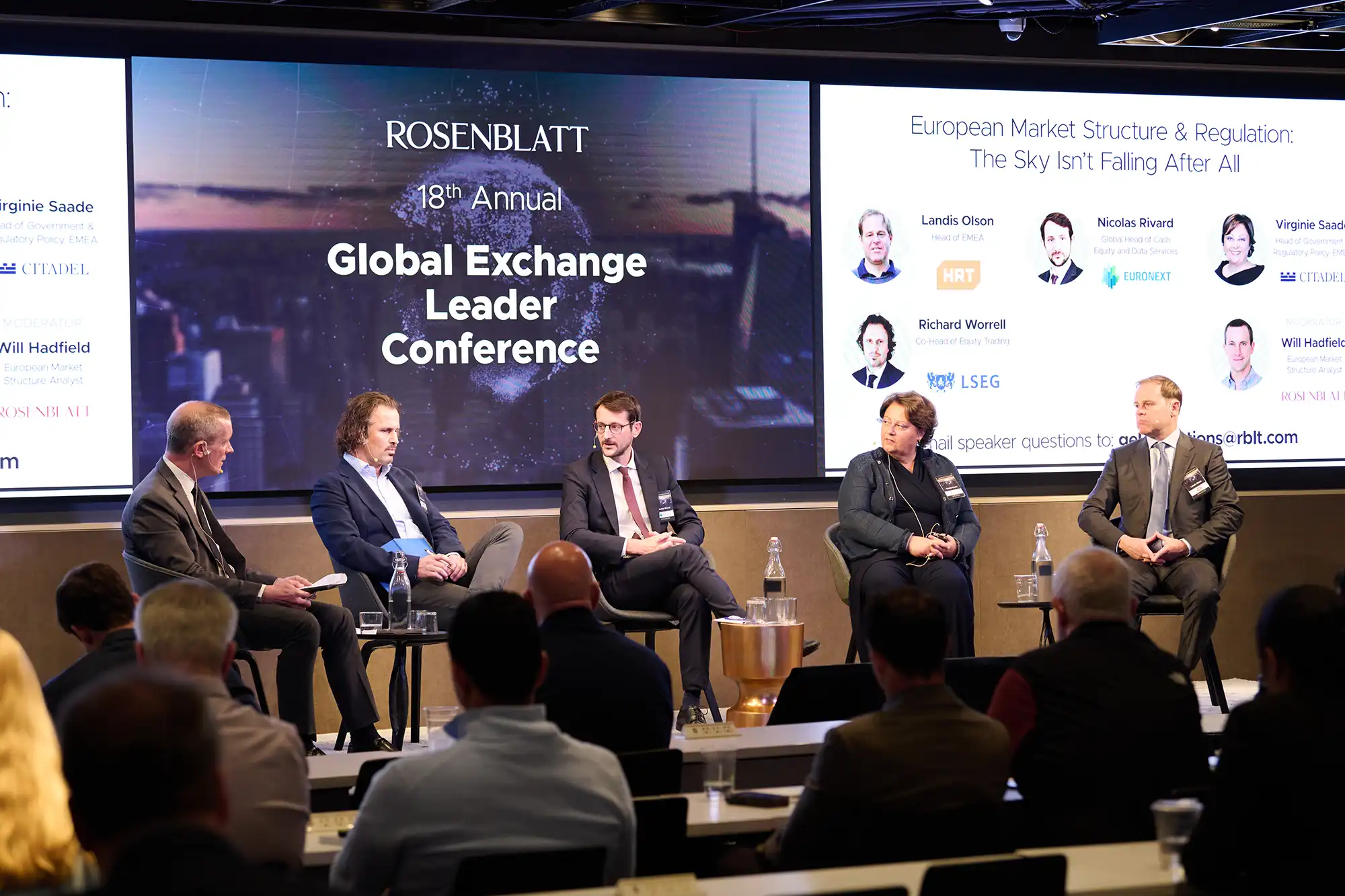 Five speakers participate in a market structure panel discussion on stage with Will Hadfield moderating.