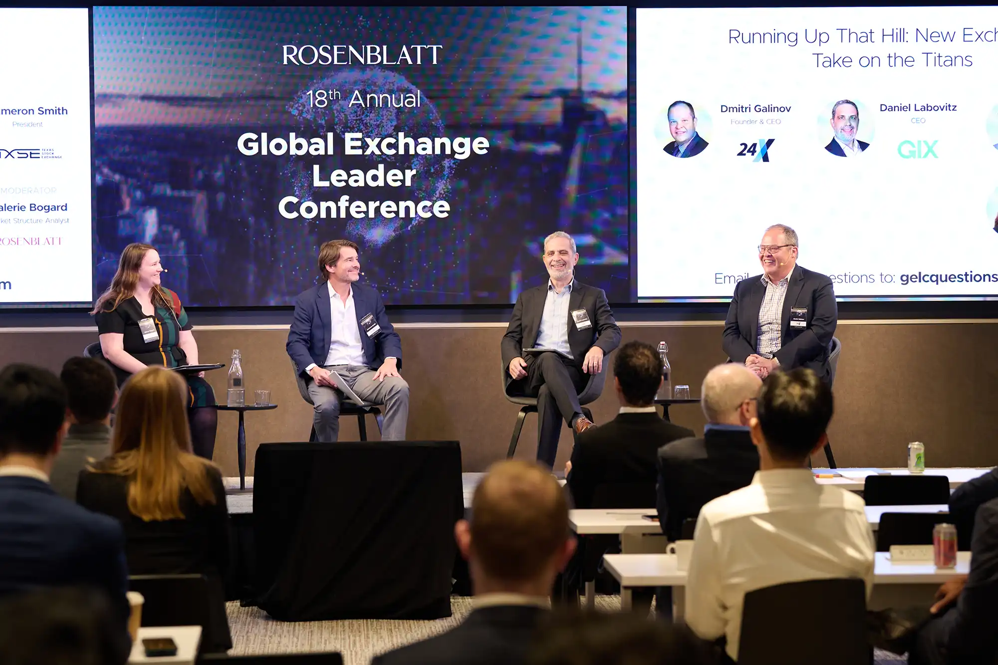 Four panelists smile and laugh together on stage in front of a digital screen at the Global Exchange Leader Conference.