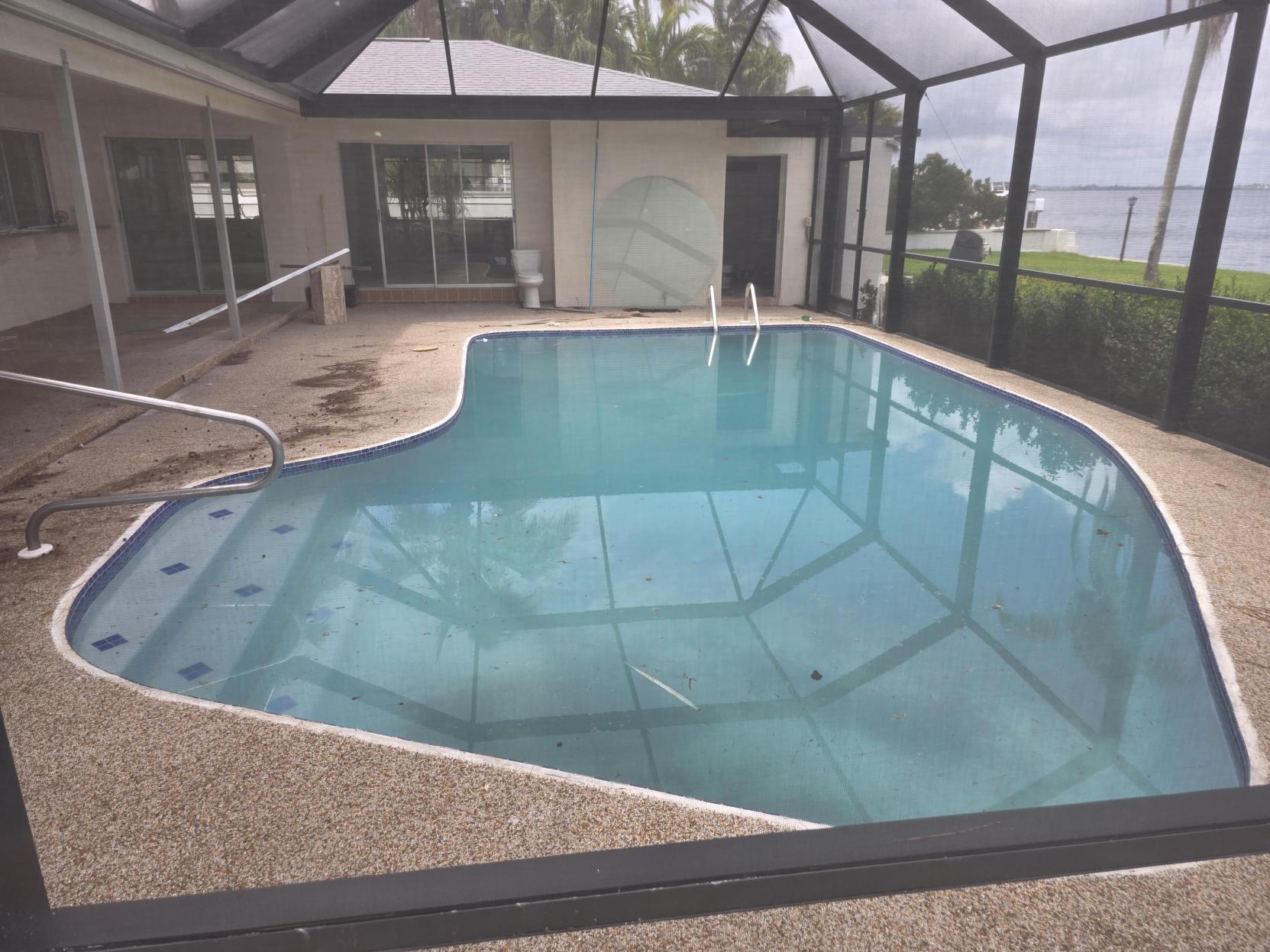Outdoor swimming pool in screened enclosure