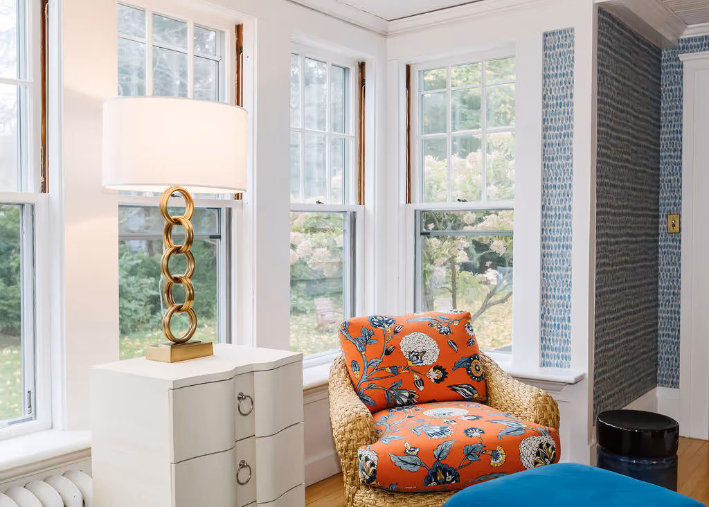 Wallpapered sunroom with wicker furniture