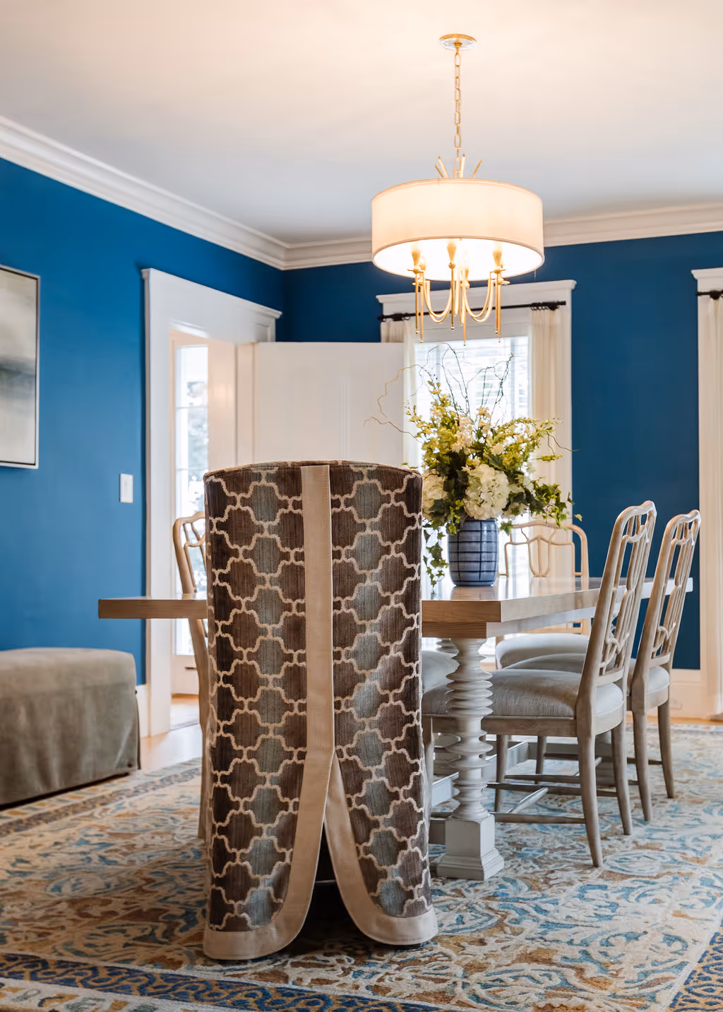 Dining room with dining table and performance fabric chairs and wool rug