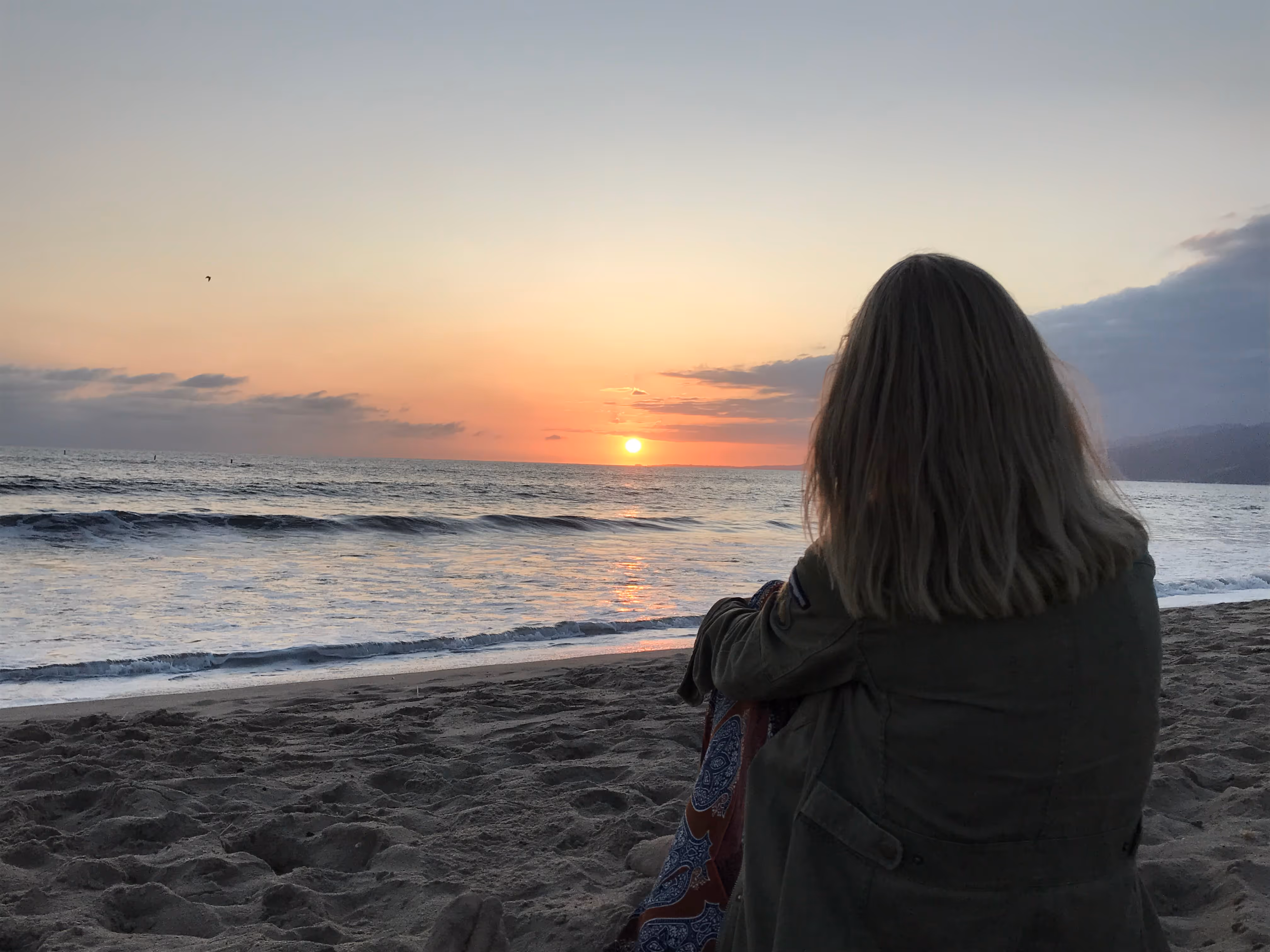 Woman at beach at sunset