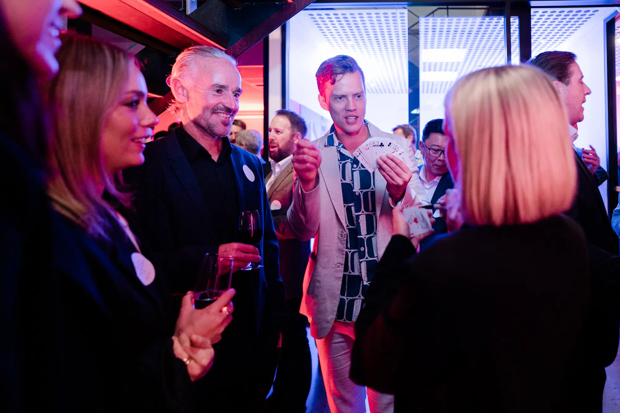Mike out at a private party performing to a group