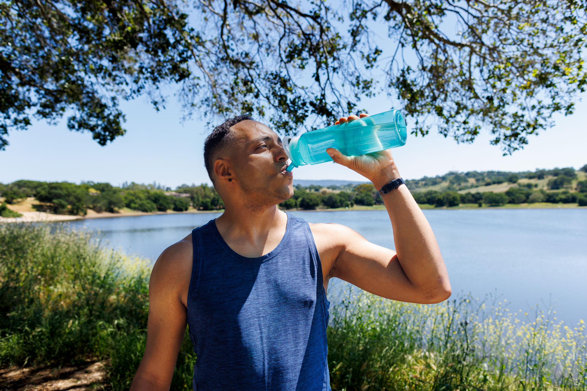 Male Fitness Content Creator drinking water from a water bottle