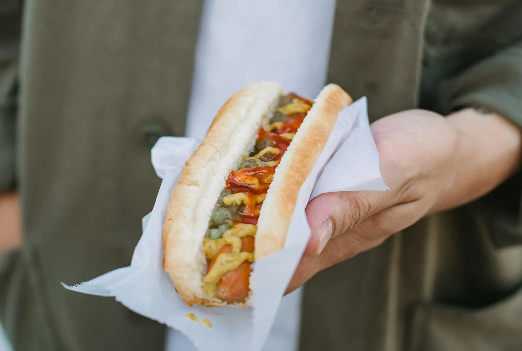 Grilled hot dog in a bun served at a golf outing.