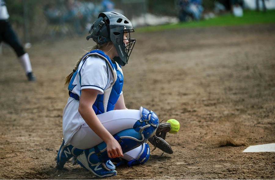 Little league softball catchers require equipment, often supplied by fundraising.