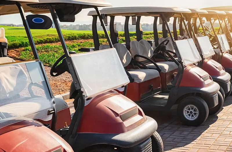 Golf carts lined up during a golf outing fundraiser.