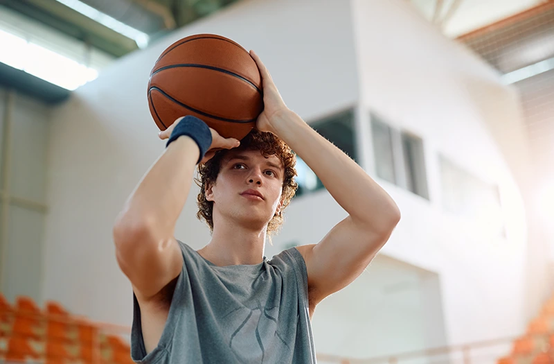 Kid shoots a basketball during a shoot-a-thon fundraiser.