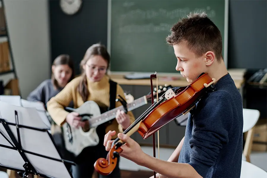 Kids practicing during an orchestra summer camp fundraiser.