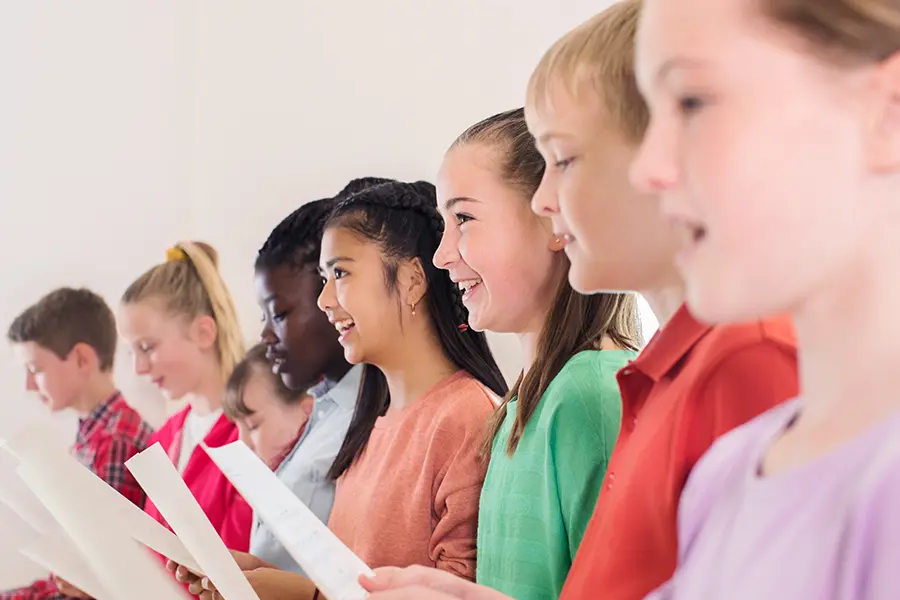 Choir students singing during a middle school choir concert fundraiser.