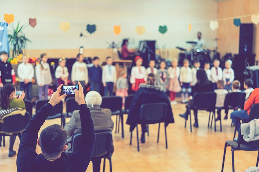 Kids singing in a school choir, benefited by performing arts fundraising.