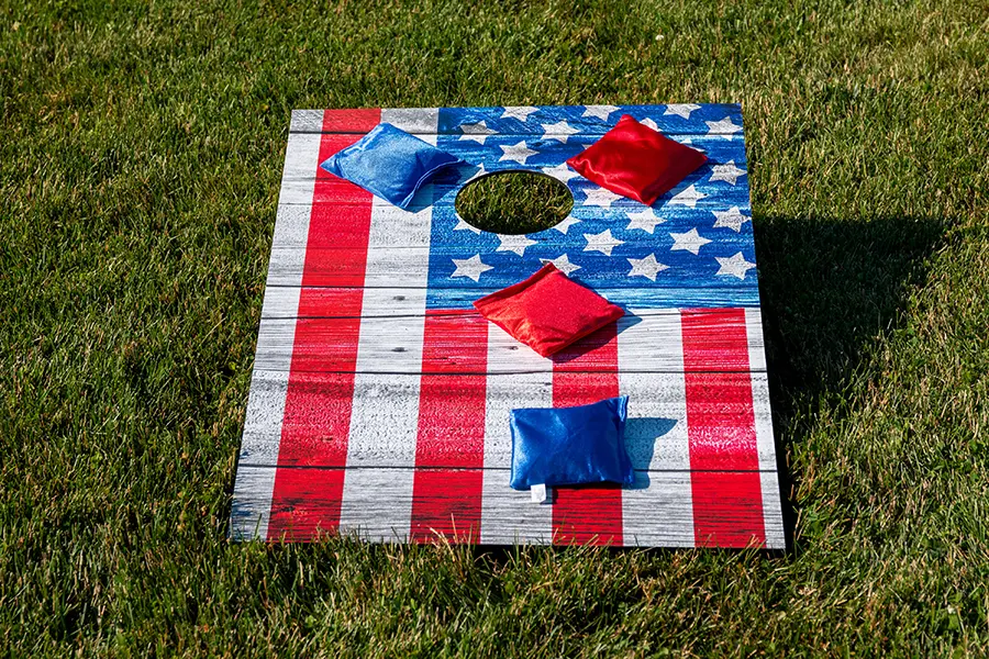 American-flag cornhole board at a lacrosse fundraiser.