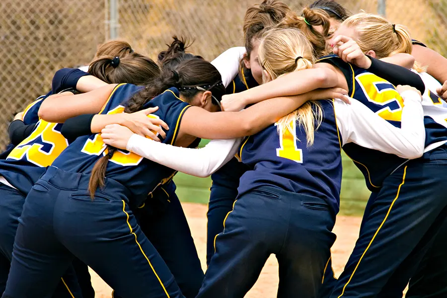 A softball team in uniforms made possibly by youth sports fundraising.