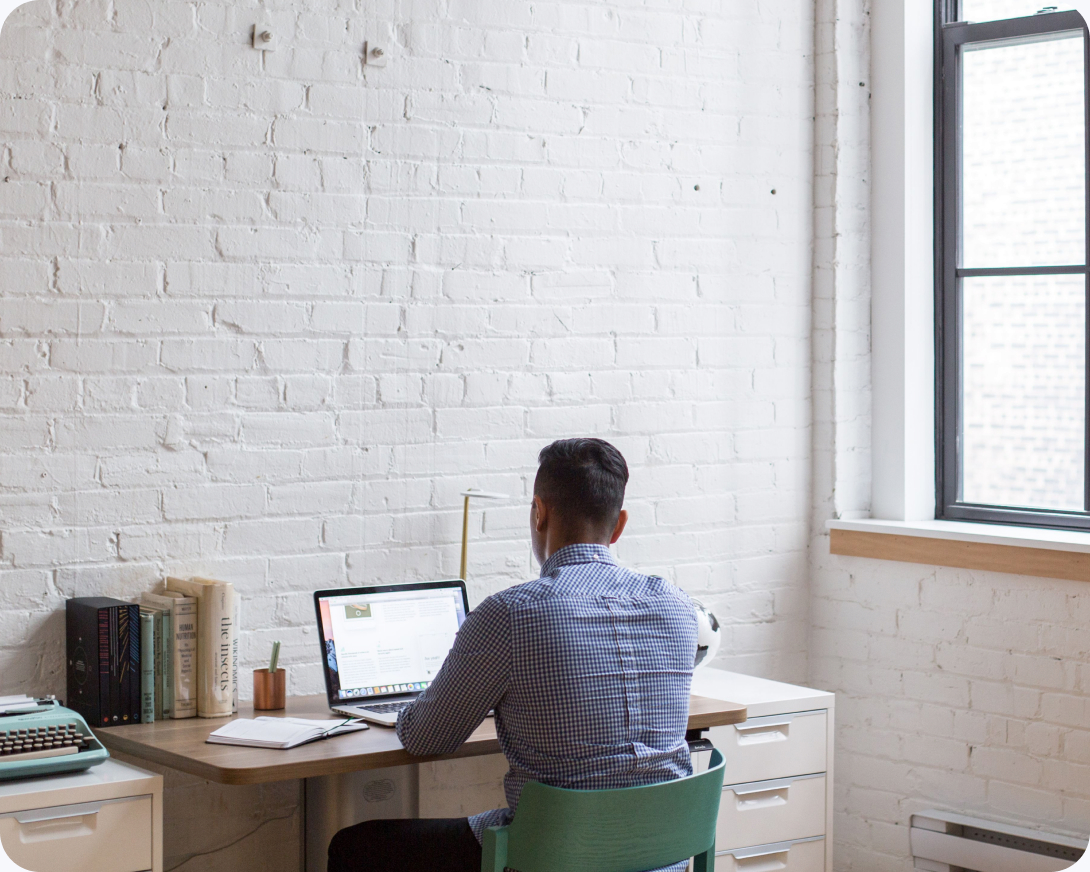 Team member working at a laptop at a desk