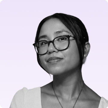 Headshot of Juliana Isabel Valera, Content Marketing specialist at alpha.one, wearing glasses and smiling against a light background.
